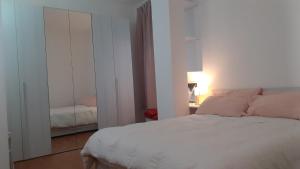 a bedroom with a white bed and a mirror at B&B LA MARCHESA in SantʼAnastasia +19 photos