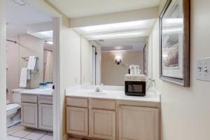 a bathroom with a sink and a mirror at Hotel Side Condo at Amelia Island Plantation with Balcony, WiFi & Shared Pool in Fernandina Beach