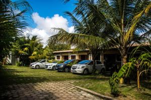 a row of cars parked in front of a house at Chalés Pipa in Pipa