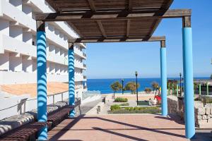 a building with the ocean in the background at Apartamentos Don Quijote in Cala Ratjada