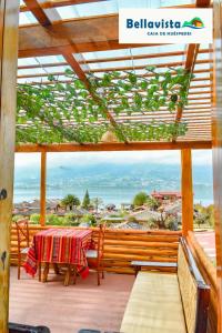 a patio with a table and a view of the ocean at Bellavista Casa de Huéspedes in San Pablo
