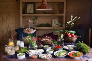 a table with many bowls of food on it at Leśniczówka u Zięby in Kościelisko