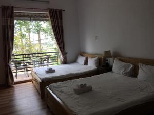 מיטה או מיטות בחדר ב-Hana Riverside Villa