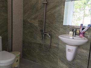 a bathroom with a toilet and a sink and a shower at Hana Riverside Villa in Quang Ngai