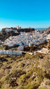 a town on a hill with white buildings at Villa 38 in Casares