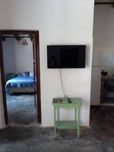 a room with a table and a tv on a wall at Misky Kucho (dulce rincon) in Maimará