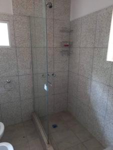 a shower with a glass door in a bathroom at Misky Kucho (dulce rincon) in Maimará