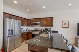 a kitchen with stainless steel appliances and wooden cabinets at Bliss Flagstaff 49 townhouse in Bellemont