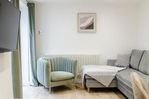 a living room with a couch and a chair at Cozy Broadstairs Hideaway - 1 min walk to beach in Kent