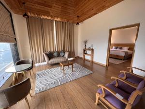 a living room with a couch and a mirror at Dandelion By The Hills in Lakhwār