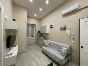 a living room with a couch and a television at Casa Cavaliere in Naples