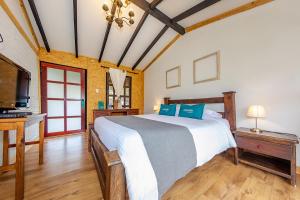 a bedroom with a bed and a flat screen tv at Ayenda Llanogrande Inn in Rionegro