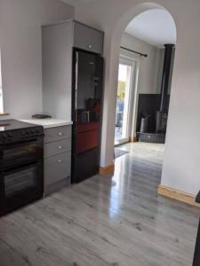 a kitchen with a stove and a counter top at The Cottage At Arvalee Retreat in Omagh