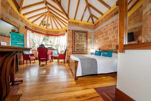 a bedroom with a bed and a table and chairs at Ayenda Llanogrande Inn in Rionegro