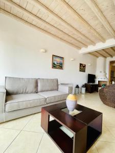 a living room with a couch and a coffee table at Natural Stone Villas in Ornos