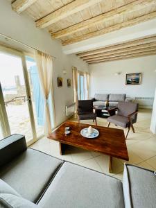 a living room with a couch and a table at Natural Stone Villas in Ornos