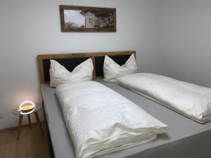 A bed or beds in a room at Schusterbrand Appartements