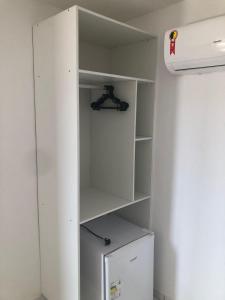 a white cupboard with a shelf in a room at Olinda mar pousada in Olinda