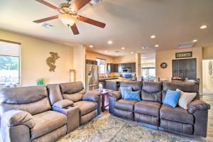 a living room with two couches and a ceiling fan at 15 Mi to Dtwn Avondale Home with Pool and Yard in Avondale