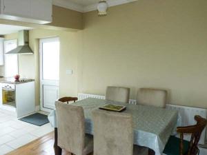 a kitchen and dining room with a table and chairs at Ocean View in Ballinskelligs