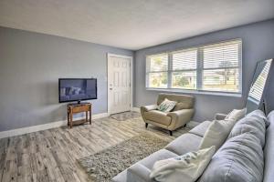 a living room with a couch and a tv at Charming Ormond Beach Home - Walk to Beach! in Ormond Beach