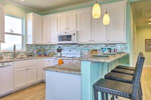 a kitchen with white cabinets and a counter top at Furnished Deck + Ocean Views: Surfside Beach Home in Surfside Beach