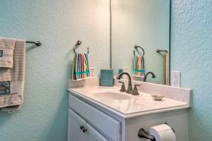 a bathroom with a sink and a mirror at Furnished Deck + Ocean Views: Surfside Beach Home in Surfside Beach +24 photos