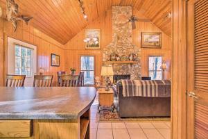 a living room with a couch and a stone fireplace at Serene Cabin with Riverfront Views and Access! in Fayetteville +28 photos