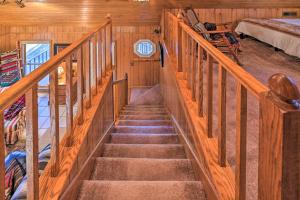 a staircase in a room with wooden walls at Serene Cabin with Riverfront Views and Access! in Fayetteville