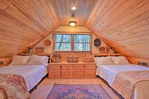 a bedroom with two beds and a window in a cabin at Serene Cabin with Riverfront Views and Access! in Fayetteville