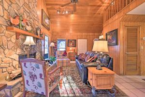 a living room with a couch and a stone wall at Serene Cabin with Riverfront Views and Access! in Fayetteville
