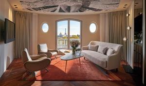 a living room with two chairs and a table at Hotel Lutetia in Paris