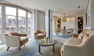 a living room with chairs and a table at Hotel Lutetia in Paris