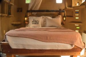 a bedroom with a bed with a wooden headboard and pillows at Lo De Ro in Barra de Valizas +46 photos