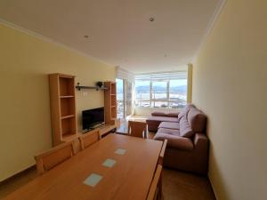 a living room with a couch and a table at Apartamentos Rapadoira in Foz