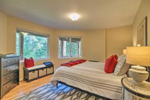 a bedroom with a large bed with red pillows at Convenient Apt with Fire Pit about Half-Mi to Lake! in Groveland
