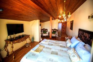 a living room with a couch and a tv at Lemon Villa Hotel - Adult Only in Alanya
