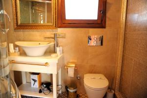 a bathroom with a sink and a toilet at Lemon Villa Hotel - Adult Only in Alanya