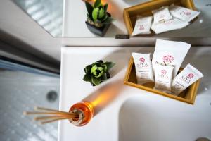 a bottle of alcohol on top of a white refrigerator at Familiaris Pompei Holiday Home in Pompei +84 photos