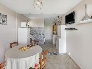 a kitchen and dining room with a table in a room at Cozy holiday home in Thédirac in Thédirac