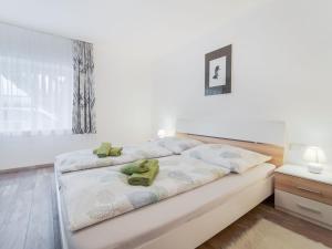 a bedroom with a bed with two green towels on it at Apartment in Bad Mitterndorf near ski area in Bad Mitterndorf