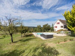 a house with a swimming pool in a yard at Cozy holiday home in Thédirac in Thédirac