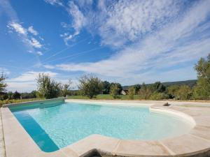 an empty swimming pool with a blue sky at Cozy holiday home in Thédirac in Thédirac