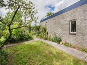 a brick wall with a window and a yard at Serene Bungalow in Landgraaf with Terrace and Nature Garden in Landgraaf