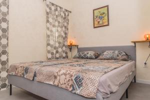 a bedroom with a bed with two candles on it at Miramar Balchik Apartment 10 in Balchik