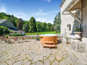 een groot bad op een stenen patio bij Castle in Ferri res with a garden terrace and pond in Ferrières