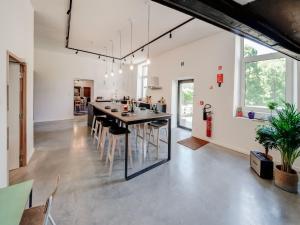 an open kitchen and dining room with a table and chairs at Castle in Ferri res with a garden terrace and pond in Ferrières