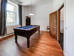 a living room with a pool table in it at Castle in Ferri res with a garden terrace and pond in Ferrières