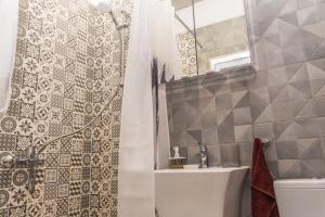 a bathroom with a shower and a toilet and a sink at Miramar Balchik Apartment 10 in Balchik