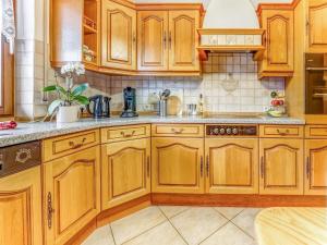 a kitchen with wooden cabinets and a sink at Spacious flat in Adenau near the N rburgring in Adenau